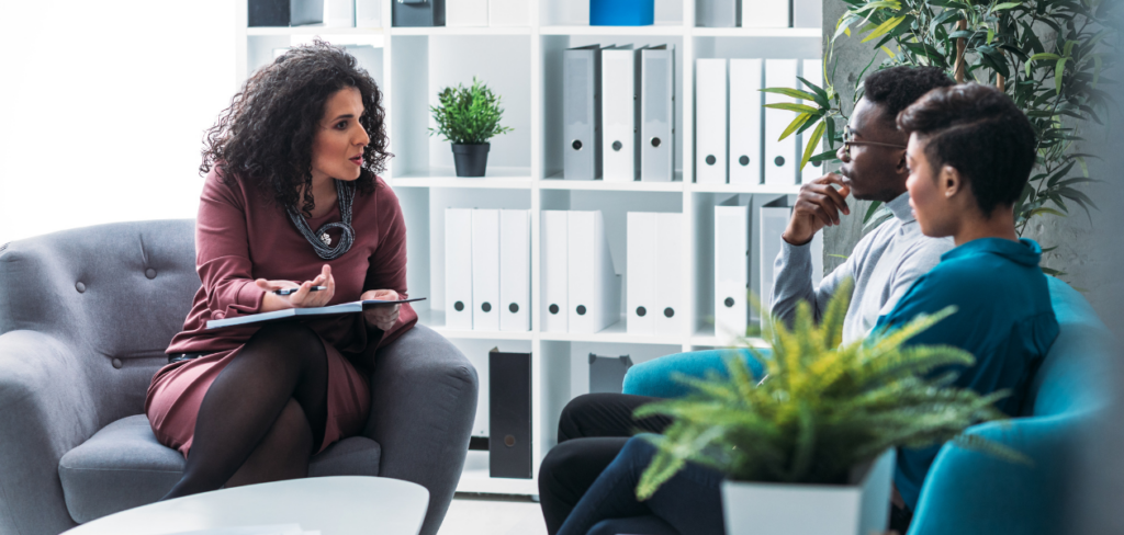 A female financial advisor is talking with her clients.
