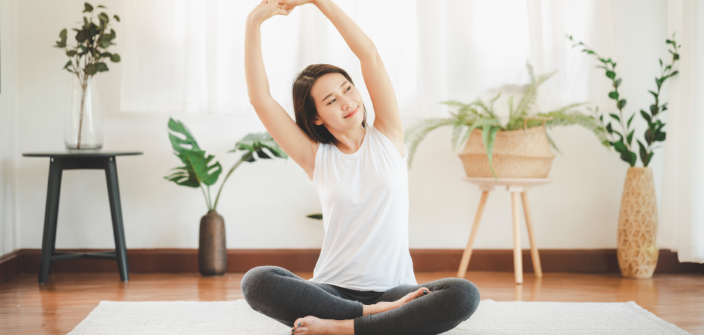 A woman is doing yoga in their living room.
