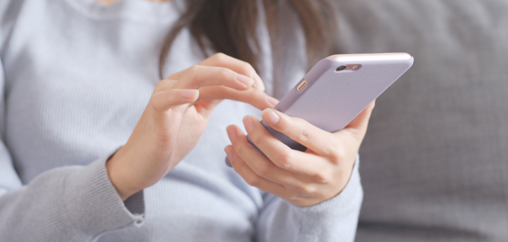A closeup shot of a woman using a mobile phone.
