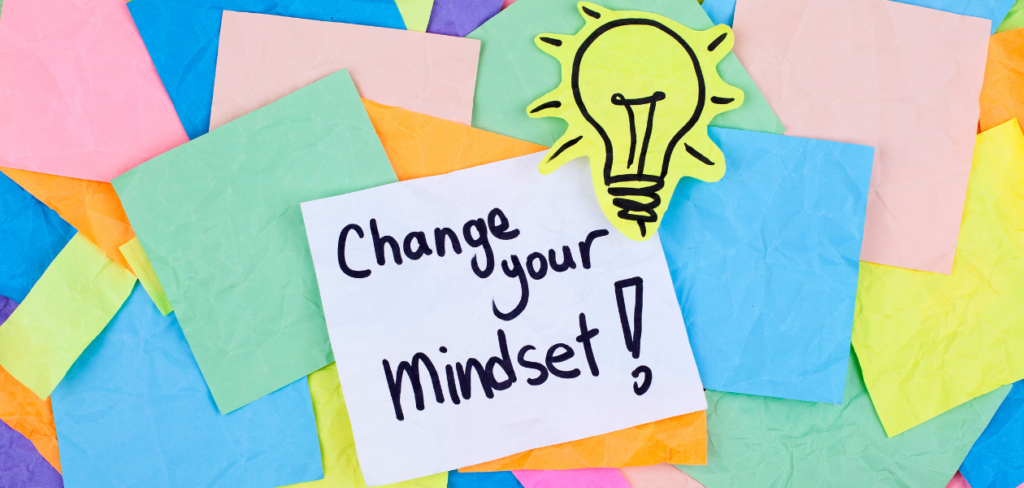 Colorful sticky notes with the words "Change Your Mindset" and a lightbulb drawing.

