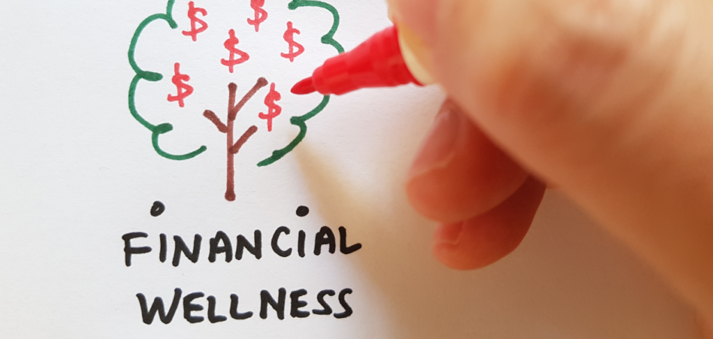 A hand is drawing a financial wellness tree on paper with a red marker.