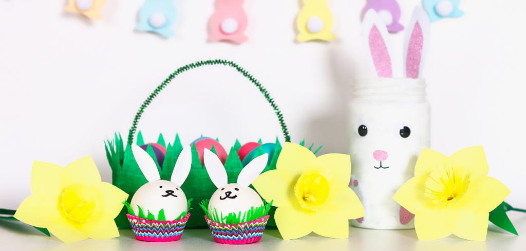 DIY Easter basket with paper garlands, paper flowers, bunny vase, egg bunnies, and a basket with painted eggs.