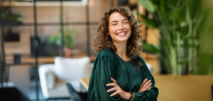A woman smiling confidently in a modern office space