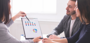 Financial advisor presenting charts and graphs to a couple.