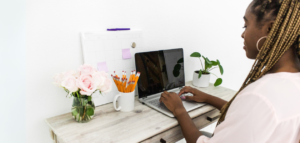 A woman sitting at a desk with a laptop.