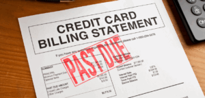A close-up shot of a credit card billing statement marked "PAST DUE" with a large red stamp. A calculator is partially visible in the corner.
