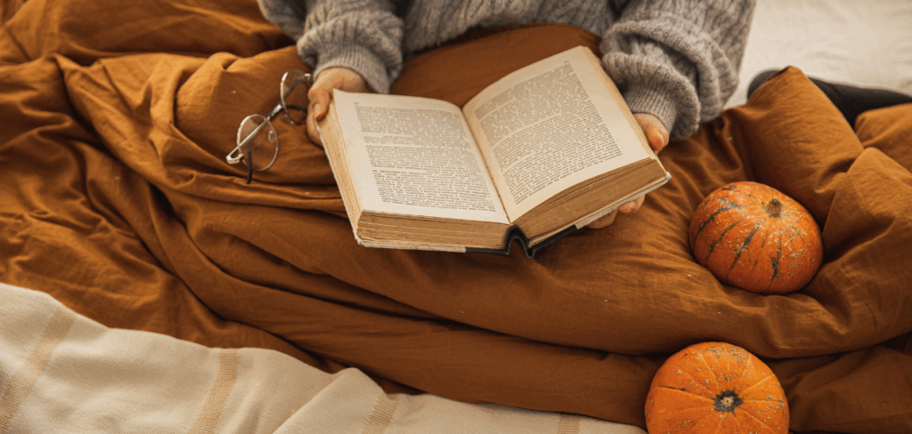 woman with a brown blanket reading